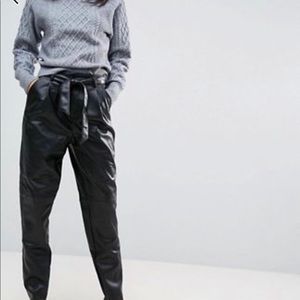 Faux leather pleated trousers.